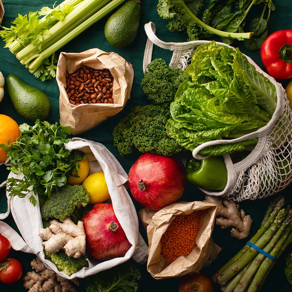 Freshly delivered locally grown fruits and vegetables packed in eco-friendly paper bags or textile shopping bags, zero waste vegetarian nutrition concept